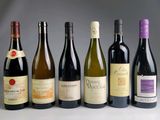 several bottles of wine are lined up in a row on a table