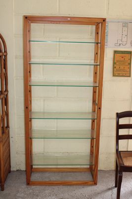 a wooden chair and a glass display case in a room