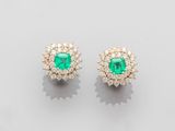 a pair of emerald and diamond earrings