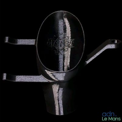 a silver spoon with a black handle on a black background