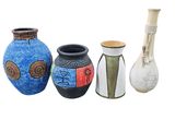 three vases sitting next to each other on a white surface