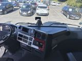 a view of a car from the driver ' s seat of a truck