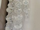 many empty wine glasses in a box on the floor