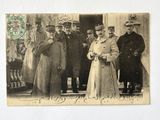 a group of men and women standing in front of a building