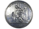 an image of a silver medal with a woman and two children