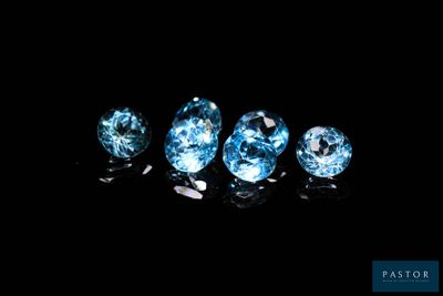 a group of three blue diamonds sitting on top of a black surface