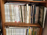 a bookshelf with many books on it in a room