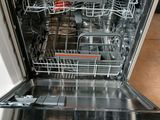 a dishwasher that is open on the counter