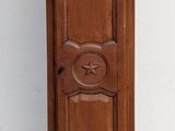 a tall wooden grandfather clock on the floor in front of a red and white wall