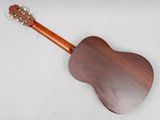 a close up of a wooden guitar on a white surface