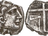 a close up of two silver coins with a cross on them