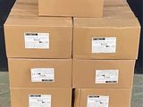 boxes stacked on a pallet in front of a black wall