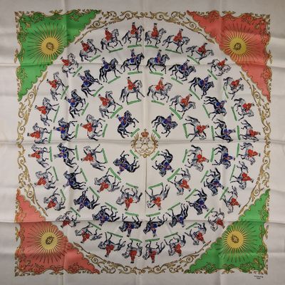 a close up of a table cloth with horses and flowers on it