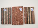 three pieces of wood with stickers on them sitting next to each other