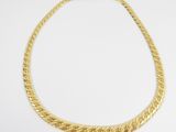 a gold necklace on a white background
