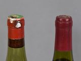 two bottles of wine sitting next to each other on a table