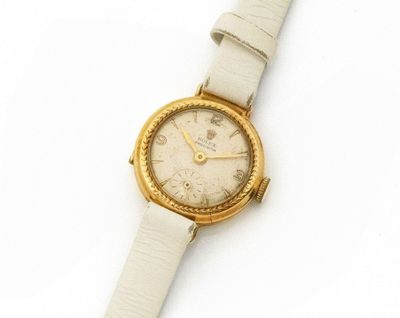 a watch that is sitting on a white surface