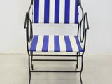 blue and white striped chair in a white room with a white wall