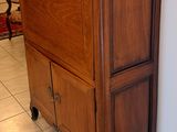 a wooden cabinet with a mirror on top of it