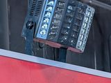a picture of a window with a red frame and a black and white accordion