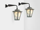 two light fixtures on a white wall in a room
