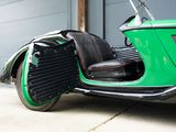 a green motorcycle parked in front of a garage door