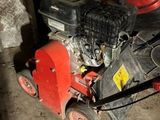 a lawn mower that is sitting on the ground