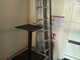 a small room with a ladder and a bed in it