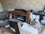 a pile of junk in a room with a brick wall