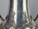 an antique silver plated coffee pot with two handles and a handle