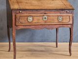 a small wooden table with two drawers on top of it