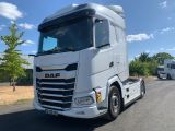 un gros camion blanc qui roule sur la route