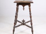 an old wooden table with a wooden top and a wooden base