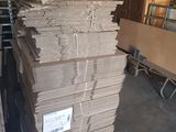 several stacks of cardboard stacked on top of each other in a warehouse