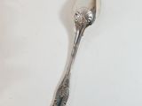 a spoon that is sitting on a white table