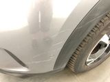 a close up of a car ' s front bumper and tire