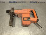 an orange and black electric drill sitting on top of a metal table