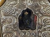 a silver purse with a picture of a person in it