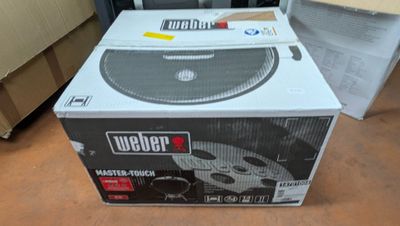 a box that is sitting on the floor next to a microwave