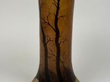 a vase that has a picture of a tree on it
