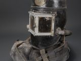 a close up of a helmet on a rock on a gray background