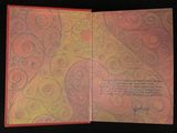 an open book with a picture of a heart on it