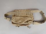 a tan bag that is sitting on a white table