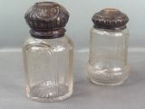 two salt and pepper shakers sitting on a table