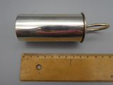 a close up of a metal object next to a ruler