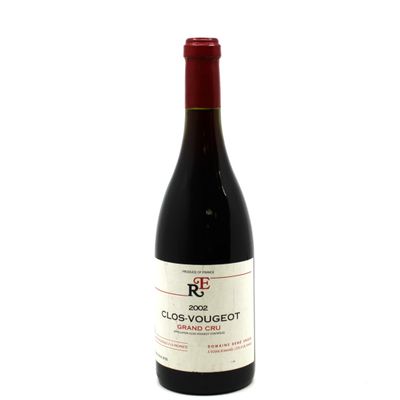 the bottle of red wine is sitting on a white surface