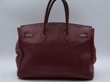 a red leather handbag on a white background