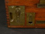 a small wooden box with a key on it