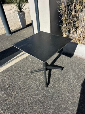 an image of a black table sitting on top of a parking lot