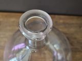 a clear glass vase sitting on a wooden table